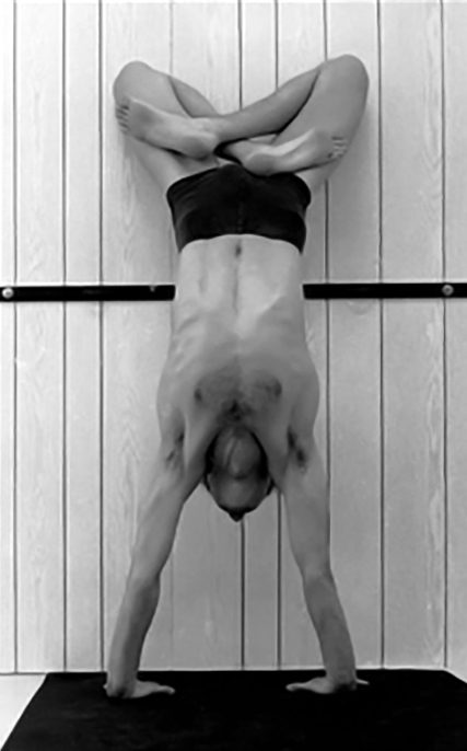 Adho-mukha-vrsasana in padmasana